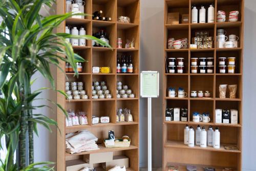 a room with a shelf filled with bottles of medicine at greet Hotel Rennes Pace in Pacé