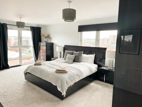 a bedroom with a large bed and a large window at Luxury 3 Bedroom Apt. Leeds Centre in Leeds