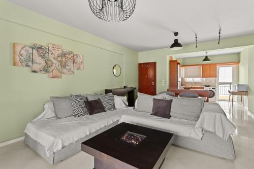 a living room with a couch and a table at Emerald Elegance in Kalamata