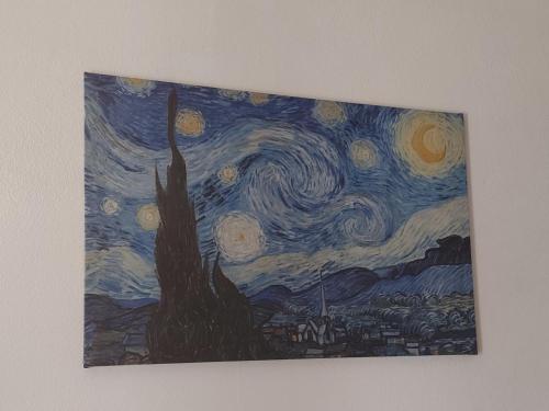 a painting of a starry sky with a tree at SU BISU Costa Rei R4991 terrace with sea view, 500m from the beach in Costa Rei
