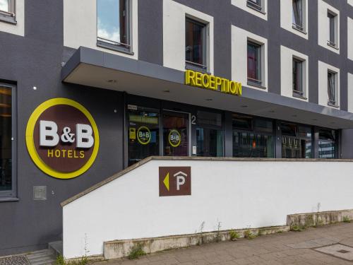 a building with a bdc hotel sign on it at B&B Hotel Düsseldorf-City in Düsseldorf