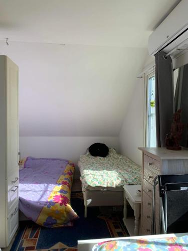 a bedroom with two beds and a desk and a mirror at Gäst lägenheten med egen terrass in Falkenberg