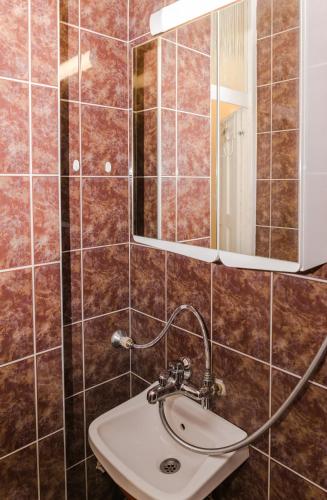 a bathroom with a sink and a mirror at Луксозен апартамент Далия in Varna City