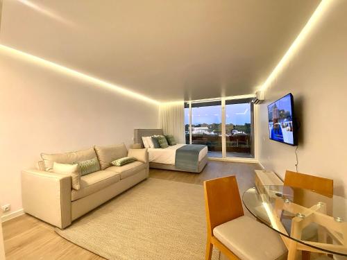 a living room with a couch and a bed at Marina Walk Apartment in Vilamoura