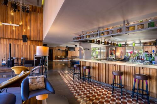 a bar with bar stools and a counter at Radisson Blu Marrakech, Carré Eden in Marrakech