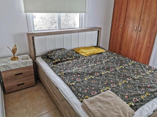 a bedroom with a bed and a window at Flemigks 1 bedroom appartement in Larnaka