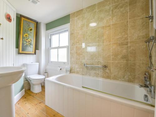 a bathroom with a tub and a toilet and a sink at 5 Exe Street in Exeter