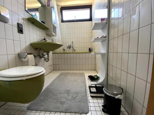 La salle de bains est pourvue de toilettes et d'un lavabo. dans l'établissement Budget Suite mit Balkon - Privatzimmer in Wohnung - NETFLIX & MINIBAR INKLUSIVE, à Coblence