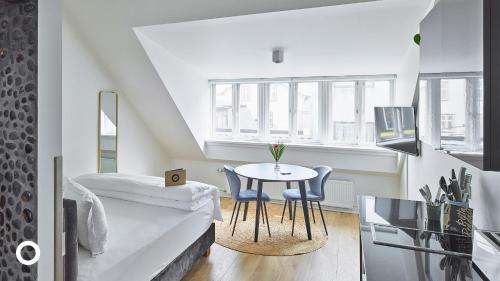 a bedroom with a bed and a table and chairs at Thingholt Hotel Apartments from Center Hotels in Reykjavík
