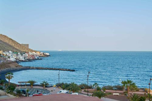 a view of a body of water with a beach at Bonita vivienda con vistas al mar playaWIFI in Radazul