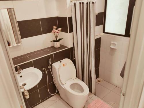 a small bathroom with a toilet and a sink at Sky Suite@Bukit Indah 2BDR-7Pax near AEON/Legoland in Johor Bahru