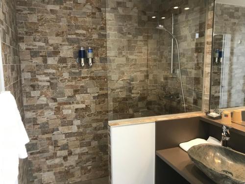 La salle de bains est pourvue d'un lavabo et d'une douche en verre. dans l'établissement Jaray-Jaclo Chambres d' hôtes, à Vieux-Boucau-les-Bains