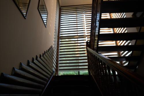 a staircase in a building with a window at Argo Guest House in Karakol