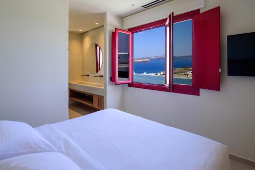 a bedroom with a bed and a window with a view at 11:11 By Potnia in Akrotiri