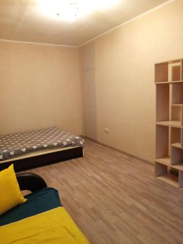 an empty room with a bed and a book shelf at Makij apartment for night 2 in Narva