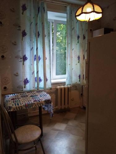 a room with a table and a window with curtains at Makij apartment for night 2 in Narva