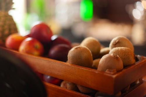 two wooden baskets filled with apples and other fruits at KING's Hotel First in Munich