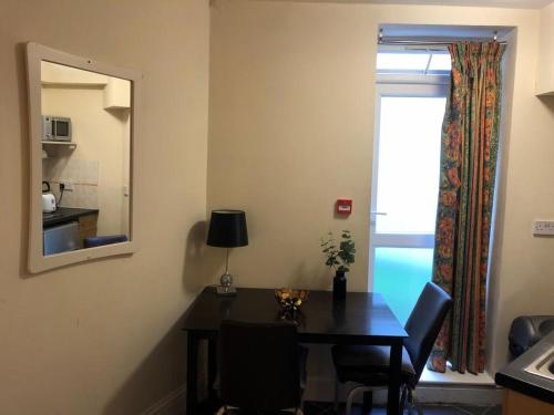 a dining room with a table and a window at Cosy 1 Bed Studio in King's Cross in London