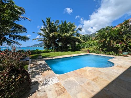 a swimming pool in the backyard of a villa at Villa Magnifique by Simply-Seychelles in Eden Island