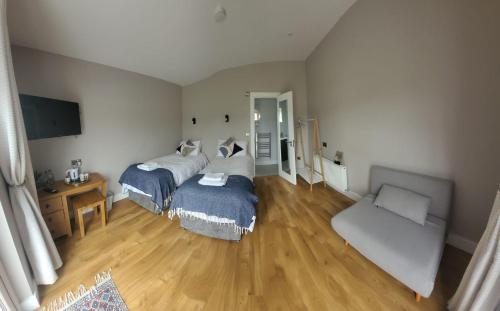 a living room with two beds and a couch at Stoneyford Luxurious Cabins in Stonyford