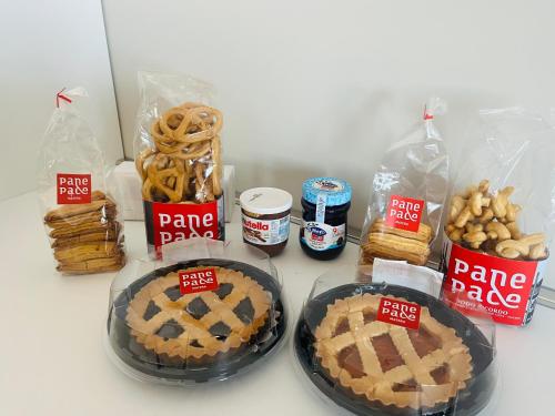 a table with two pies and other food items at Il primo sasso in Matera