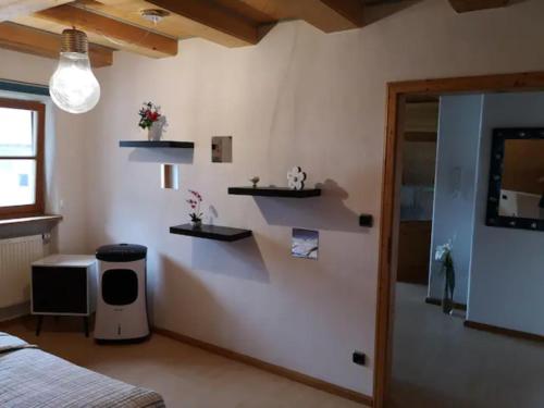 a bedroom with white walls and shelves on the wall at Antonia in Egling