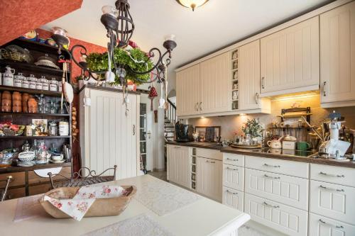 a kitchen with white cabinets and a counter at Die Kleine Oase 3 im Wohnhaus in Stuhr