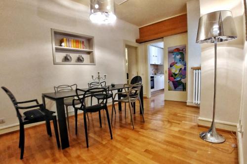a dining room with a black table and chairs at Domus Orvieto in Orvieto