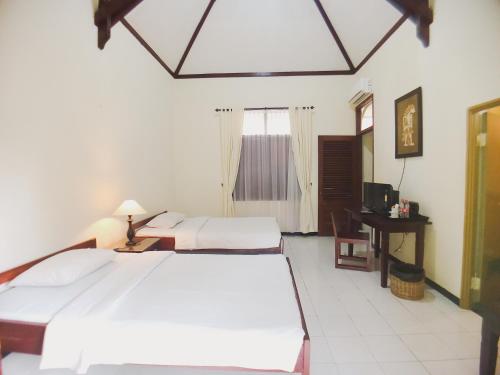 מיטה או מיטות בחדר ב-Margo Utomo Hill View Resort