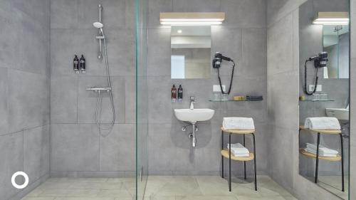 a bathroom with a shower and a sink at Center Hotels Plaza in Reykjavík