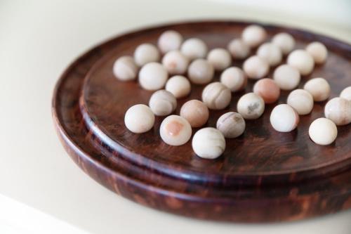 a wooden plate with a bunch of balls on it at Miravalle Lakeview by Quokka 360 - large windows and magical views in Massagno