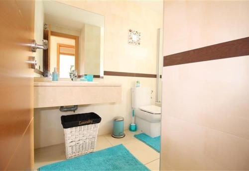 a bathroom with a sink and a toilet and a mirror at Apartment in La Cala de Mijas in La Cala de Mijas
