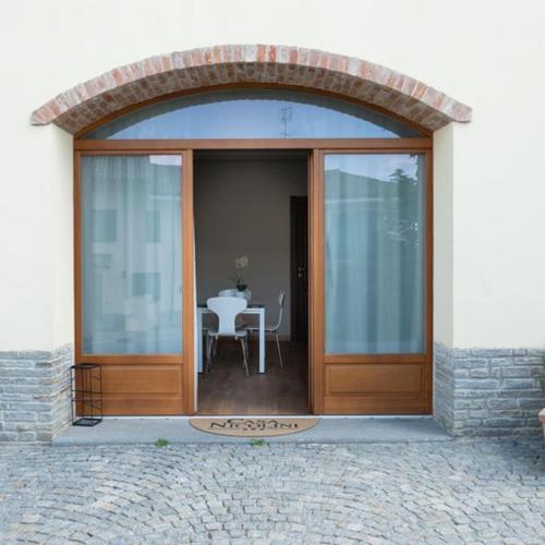 an entry to a building with a glass door with a table at Casa Nicolini in Barbaresco