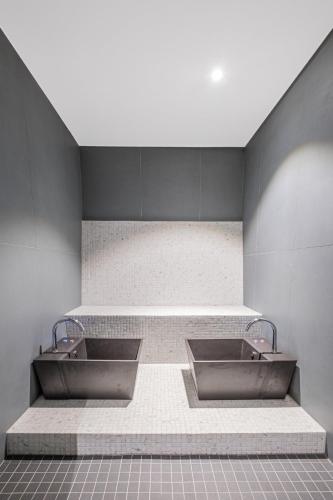 a bathroom with two sinks in a room at Chalet Les Rahâs by Mrs Miggins in Grimentz