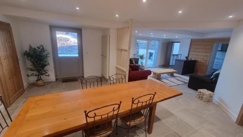 a living room with a wooden table and chairs at Chalet Terejo & spa in Ventron