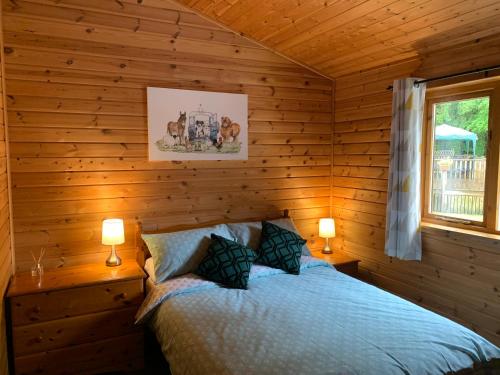 a bedroom with a bed in a log cabin at Immaculate 3-Bed Lodge in Hawick in Hawick