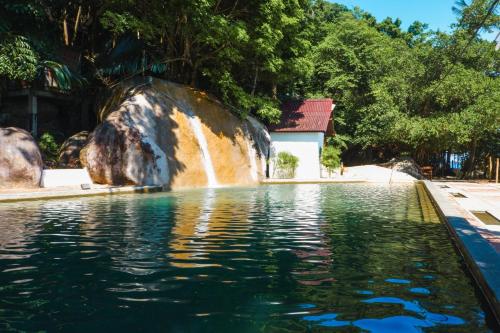 a waterfall in the middle of a pool of water at Japamala Resort by Samadhi Age 12 and Above Only in Tioman Island