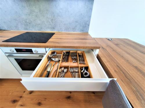 a drawer in a kitchen with utensils in it at Prestigious SKY PARK apartment - top city view - Traveller awards 2024 in Bratislava