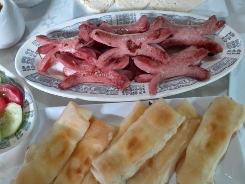 two plates of food with starfish and bread on a table at Kazbegi Guest House in Stepantsminda
