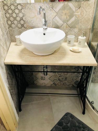 a bathroom with a white sink on a counter at Casa degli ulivi in Cuglieri