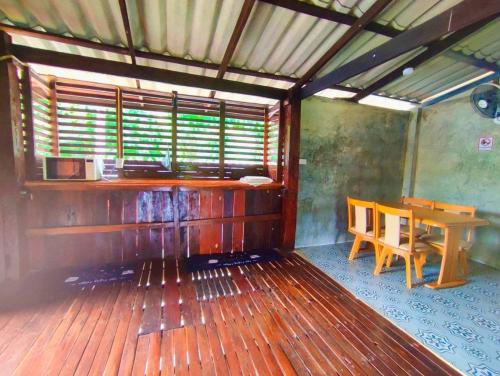 a room with a table and a table and chairs at BaanNakanoHomestay in Mae Rim