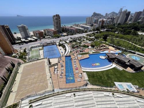 an aerial view of a swimming pool and the ocean at Luxury apartment Residencial Sunset Drive - Benidorm, España in Benidorm
