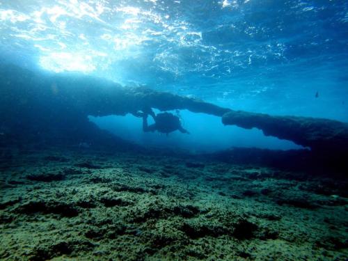 a person is swimming in the ocean near a wall at Luxury apartment Residencial Sunset Drive - Benidorm, España in Benidorm
