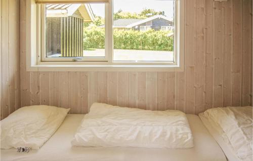 a bed in a room with a window at Holiday Home Enebærvænget Humble Ii in Nyby