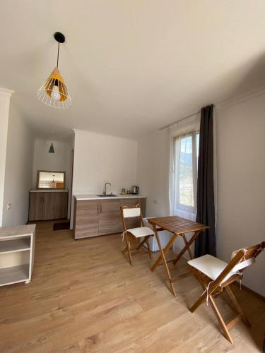 a living room with a table and chairs and a desk at Cottage Qel in Mestia