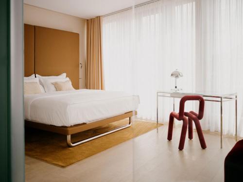 a bedroom with a bed and a table and a chair at Hotel Josef in Prague