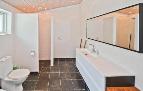 a bathroom with a white sink and a toilet at 3 Bedroom Gorgeous Home In Rnde in Dagstrup