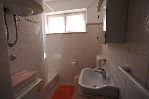 a small bathroom with a sink and a toilet at Apartment in Silo/Insel Krk 14533 in Šilo