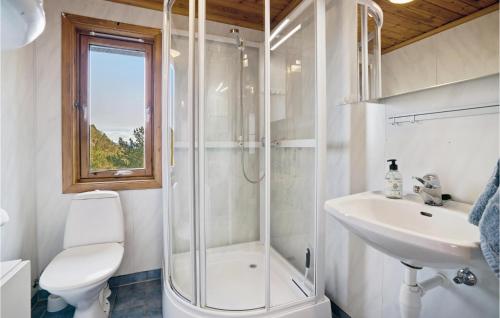a bathroom with a shower and a sink and a toilet at Nice Home In Valevg With Sauna And 2 Bedrooms in Valevåg