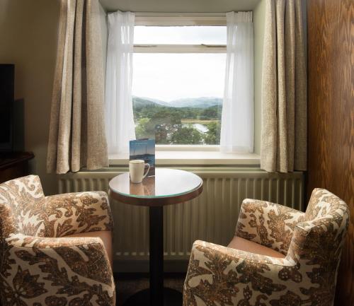 a room with two chairs and a table and a window at The Lakehouse Rooms at The Waterhead Inn, Ambleside in Ambleside